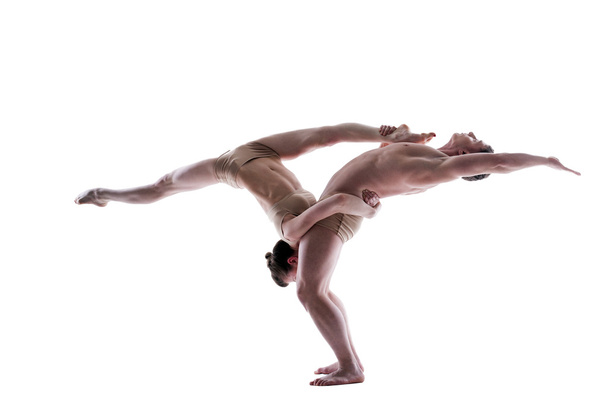 Attractive young gymnasts show acrobatics - Zdjęcie, obraz