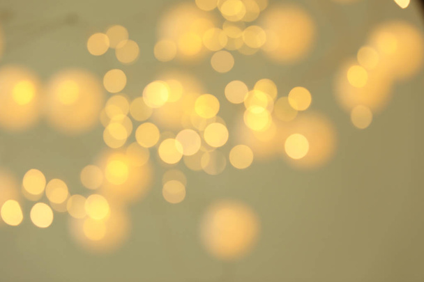 Blurred view of shiny gold lights. Bokeh effect - Photo, Image