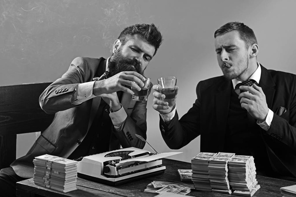 Business is over. Businessmen write financial report while drinking and smoking. Successful investment in business. Business partners with cash money. Money brokers counting profit increase - Фото, изображение