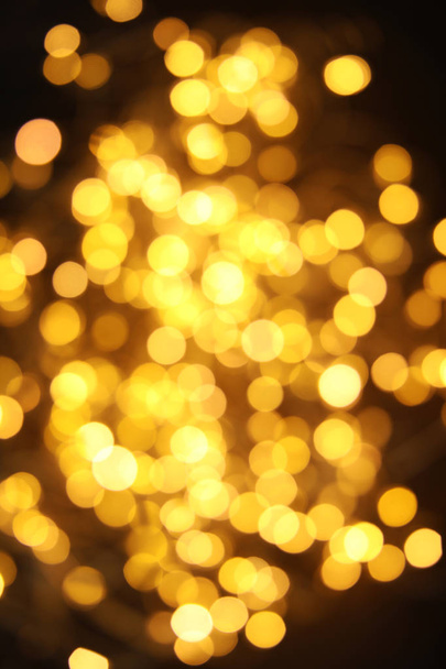 Gold glitter with bokeh effect on dark background - Φωτογραφία, εικόνα