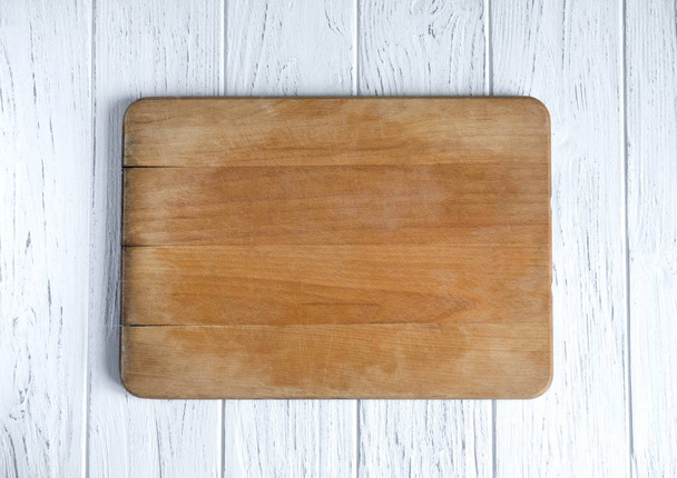 Space for text in the form of an old kitchen board on a white wooden background. Frame for text. Kitchen frame for text. View from above - 写真・画像