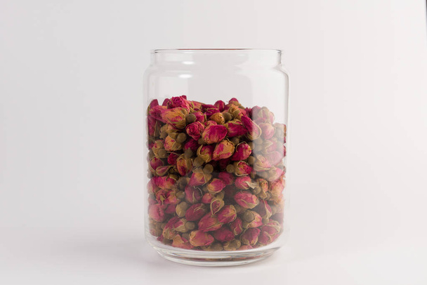 tea rose buds in the transparent jar isolated on white background - Zdjęcie, obraz