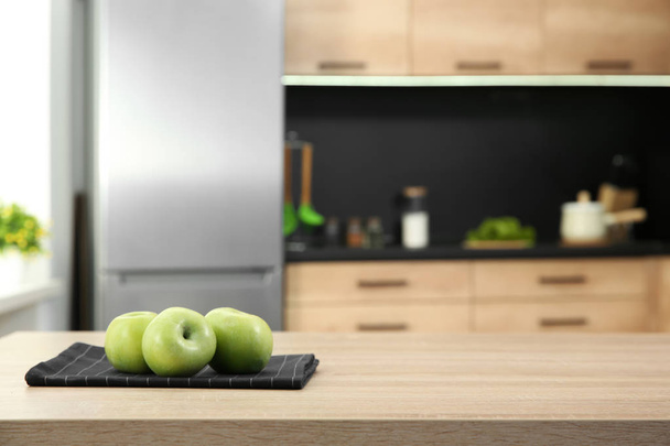 Fresh apples on table in kitchen, selective focus - Foto, imagen