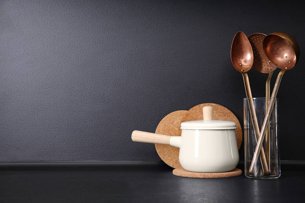 Composition with kitchenware on table against grey background. Space for text - Foto, afbeelding