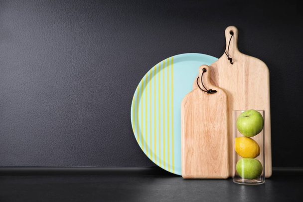 Composition with kitchenware and fruits on table against grey background. Space for text - Photo, Image