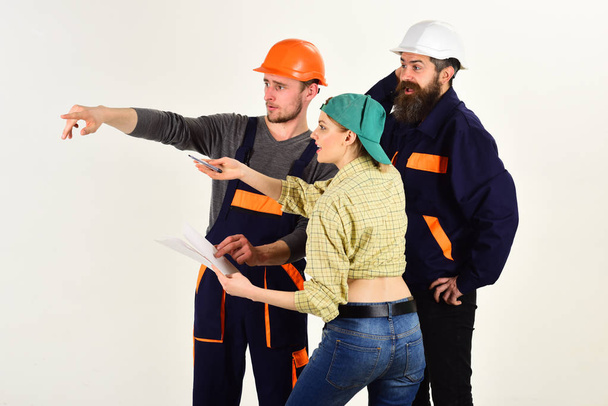Teamwork is a key to success. Group of constructing engineers and architects at work. Men and woman builders working in team. Construction workers team. People working together on construction design - Фото, зображення