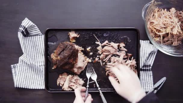Flat lay. Step by step. Shredding pork roast shoulder with two forks. - Footage, Video