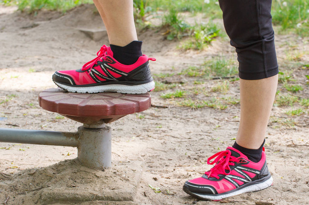 Legs of elderly senior woman on outdoor gym, healthy lifestyle concept - Foto, Bild