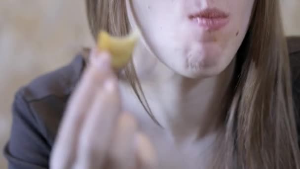 close-up. Sexy girl eats fast food. Eats french fries. Concept of healthy eating and obesity society - Materiał filmowy, wideo