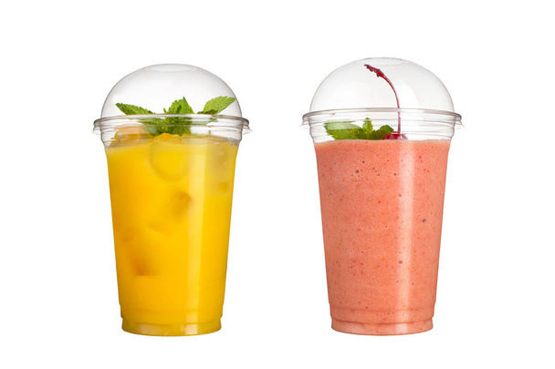 Delicious fruit smoothies in plastic cups, on a white background. Two cocktails with a taste of pineapple and cherry. - Foto, imagen