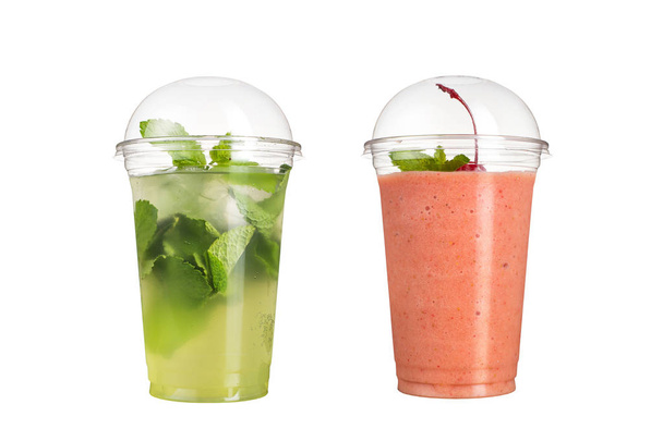 Delicious fruit smoothies in plastic cups, on a white background. Two cocktails with a taste of mojito and cherry. - 写真・画像