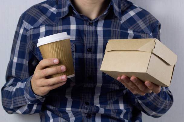man with coffee and food box to go - Foto, afbeelding