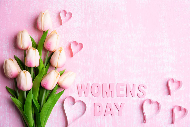 Womens day concept. Pink tulips and paper hearts with Wooden let - Photo, Image