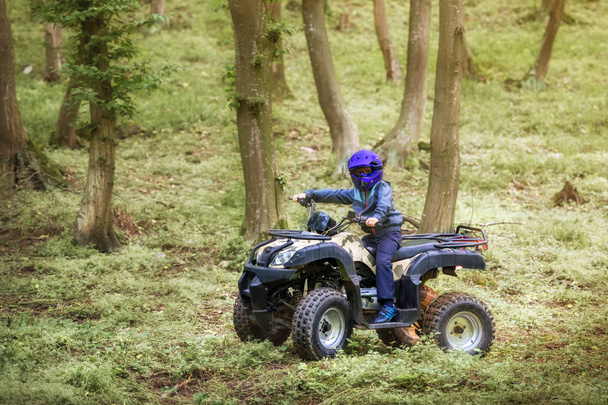 The boy is traveling on an ATV. - Photo, Image