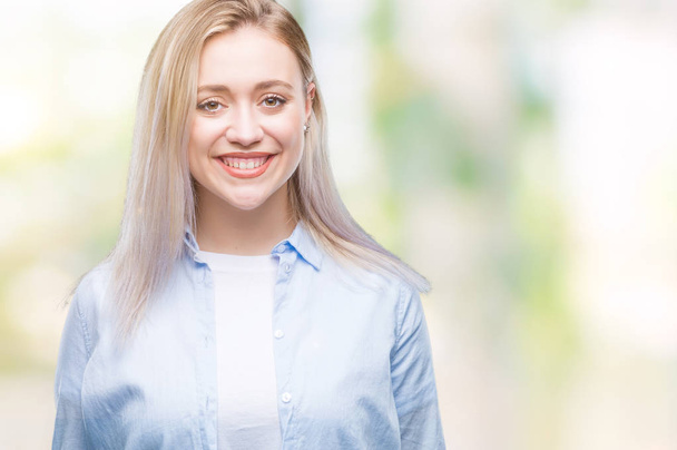 Young blonde woman over isolated background with a happy and cool smile on face. Lucky person. - Photo, Image