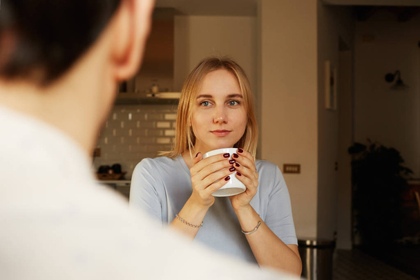 Conversation of confident man and young blond woman at home - Photo, image