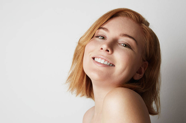 Profile portrait of beauty female redhead model with happy smiling and light nude make-up. Background. - Φωτογραφία, εικόνα