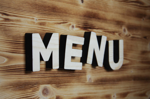 MENU word made with building blocks on wooden board - Foto, afbeelding
