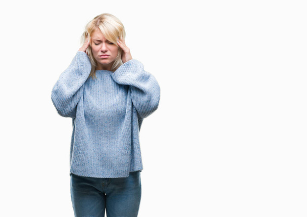 Young beautiful blonde woman wearing winter sweater over isolated background with hand on head for pain in head because stress. Suffering migraine. - Фото, изображение