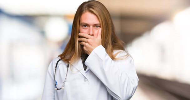 Доктор чоловік прикриває рот руками, щоб сказати щось недоречне в лікарні
 - Фото, зображення