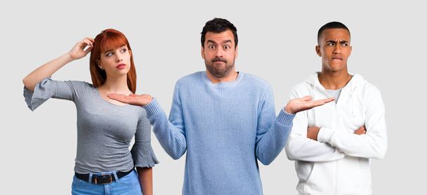 Group of three friends having doubts and with confuse face expre - Photo, Image