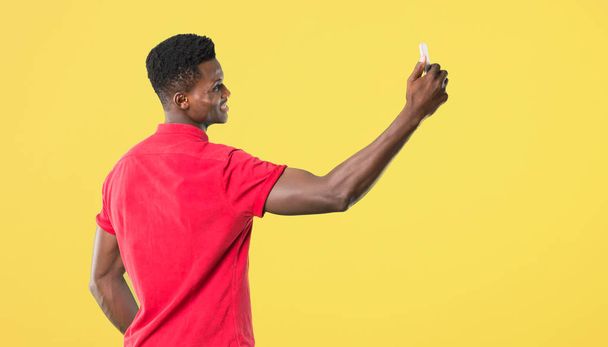 Young african american man taking a selfie with the mobile on ye - Photo, image