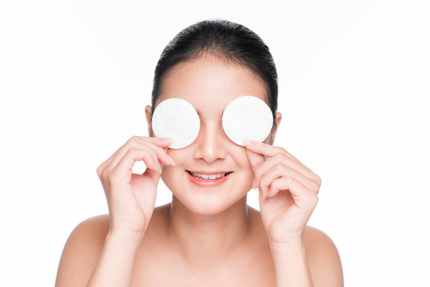 Young asian girl cares for face skin relaxation using cotton pad - Photo, Image