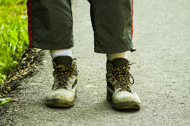Hiking feet with used hiking boots - 写真・画像