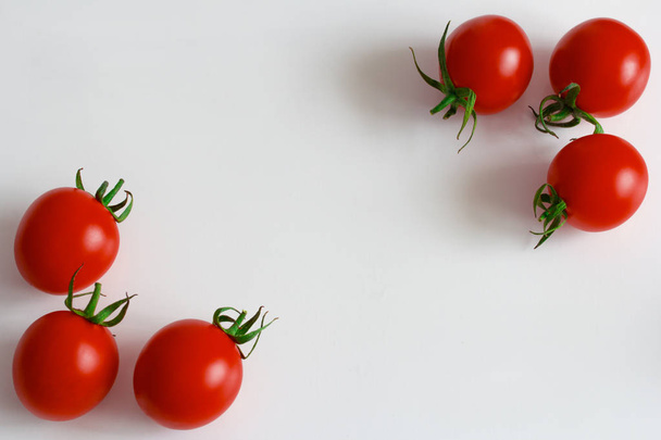 red ripe cherry tomatoes on a white background - 写真・画像