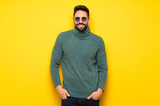 Handsome man with sunglasses posing and laughing looking to the front - Photo, Image