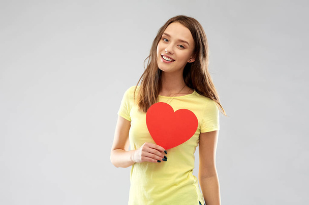 smiling teenage girl with red heart - Foto, Imagem