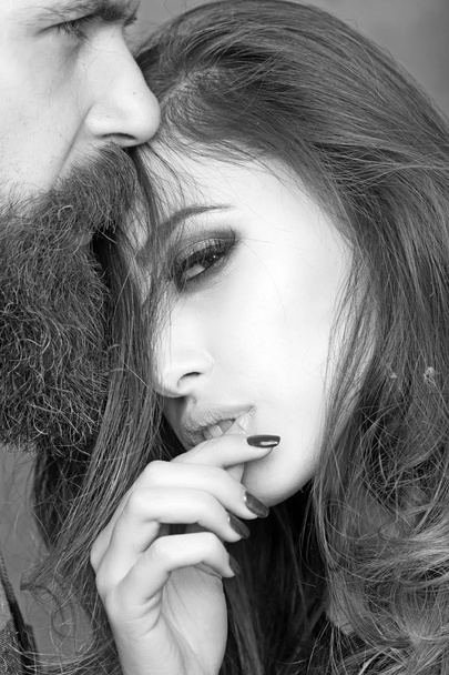 Bearded man looks far away while lovely brunette woman pose with cute face - 写真・画像