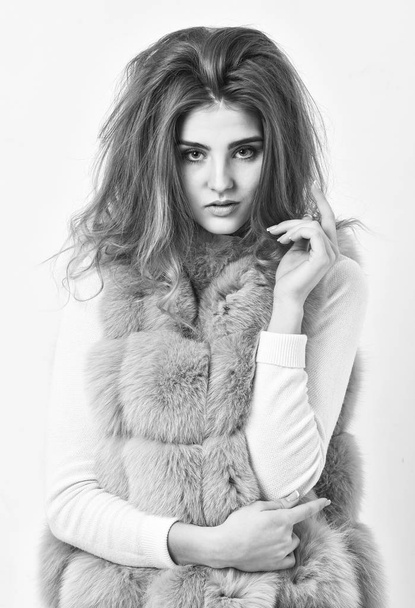 Girl fur coat posing with hairstyle on white background. Winter hair care tips you should follow. Hair care concept. Prevent winter hair damage. Woman makeup face touch hair volume hairstyle - Photo, image