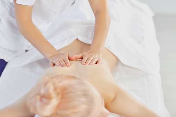 Young woman doing massage in the spa salon - Foto, immagini