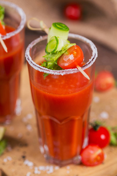 Two glasses of fresh organic tomato juice decorated with raw tom - Foto, imagen