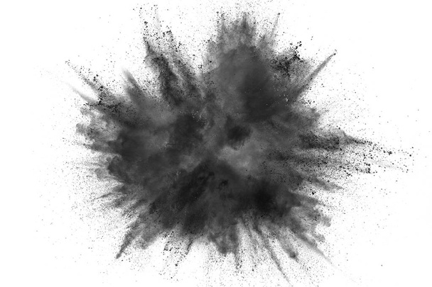 Black powder explosion on white background.Black dust particles splash.Painted Holi powder festival. - Photo, Image