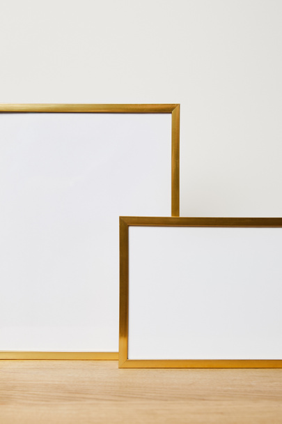 decorative blank frames on wooden table at home - Valokuva, kuva