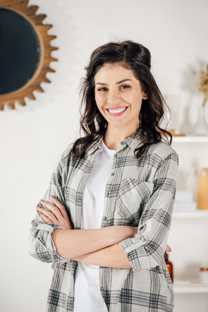 woman in grey shirt smiling at home - Photo, Image