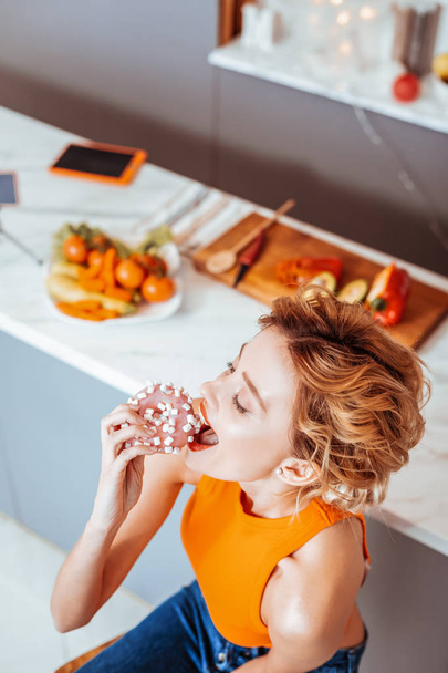 Top view of a happy nice woman eating - Photo, image