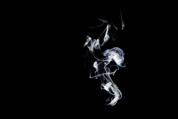 Smoke incense on a black background, abstract photo with swirls in the air - Foto, Imagem