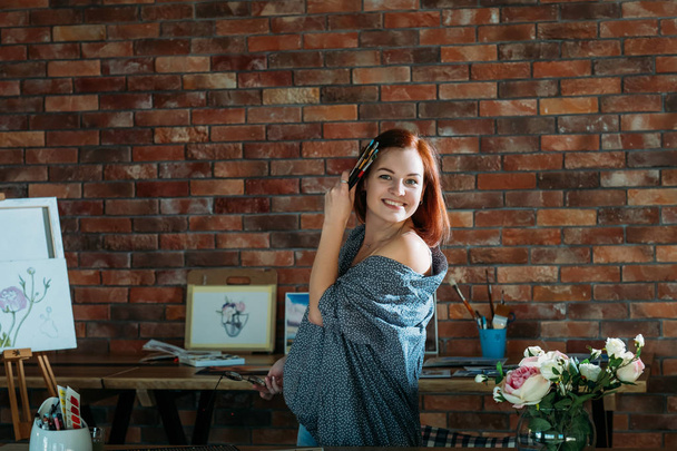 creative artist workspace redhead female posing - 写真・画像