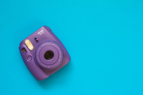 Fujifilm instax mini camera  instant film on blue background - Foto, Imagem