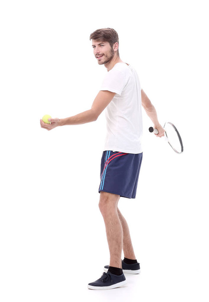 side view.smiling man with tennis racket. - Foto, afbeelding