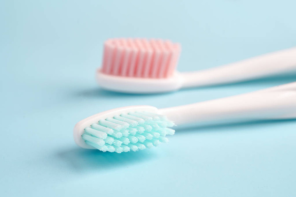 Toothbrushes on color table - Φωτογραφία, εικόνα