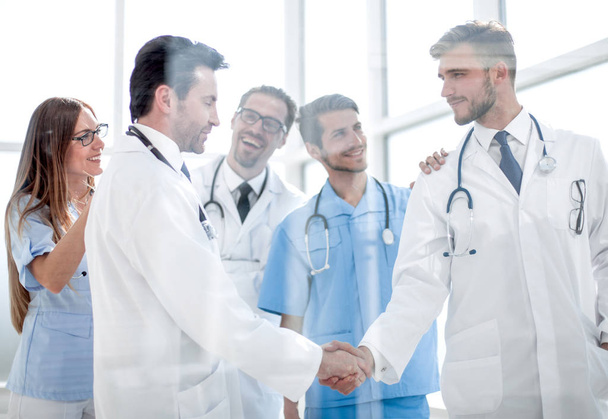 doctors shaking hands in hospital corridor - 写真・画像