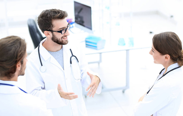 Medical staff discuss in a modern hospital room - Фото, зображення