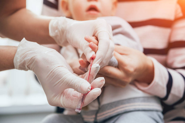 Nurse taking a little child blood sample. Medical equipment. Blood test - Фото, изображение