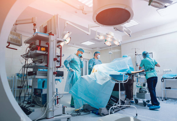 外傷手術のプロセス.手術室の外科医のグループX線装置.医学的背景 - 写真・画像