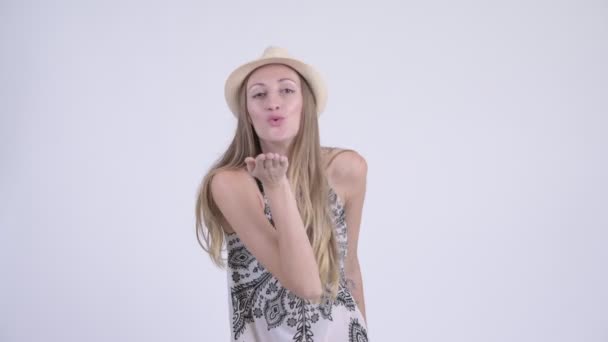 Portrait of happy blonde tourist woman blowing kiss - Footage, Video