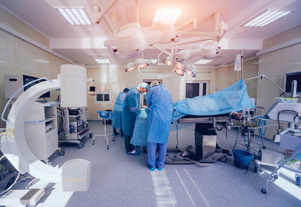 Διαδικασία της τραύμα χειρουργικής επέμβασης. Ομάδα χειρουργών στο λειτουργικό δωμάτιο με εξοπλισμό χειρουργική επέμβαση. Ιατρικό ιστορικό - Φωτογραφία, εικόνα